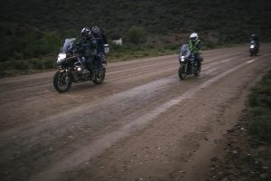 A BMW 1200 GS and a Zontes 310 T on a wet gravel road