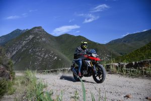Test-riding the BMW G 310 GS on a smooth gravel road